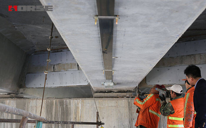 Prestressed carbon fiber plate for bridge reinforcement